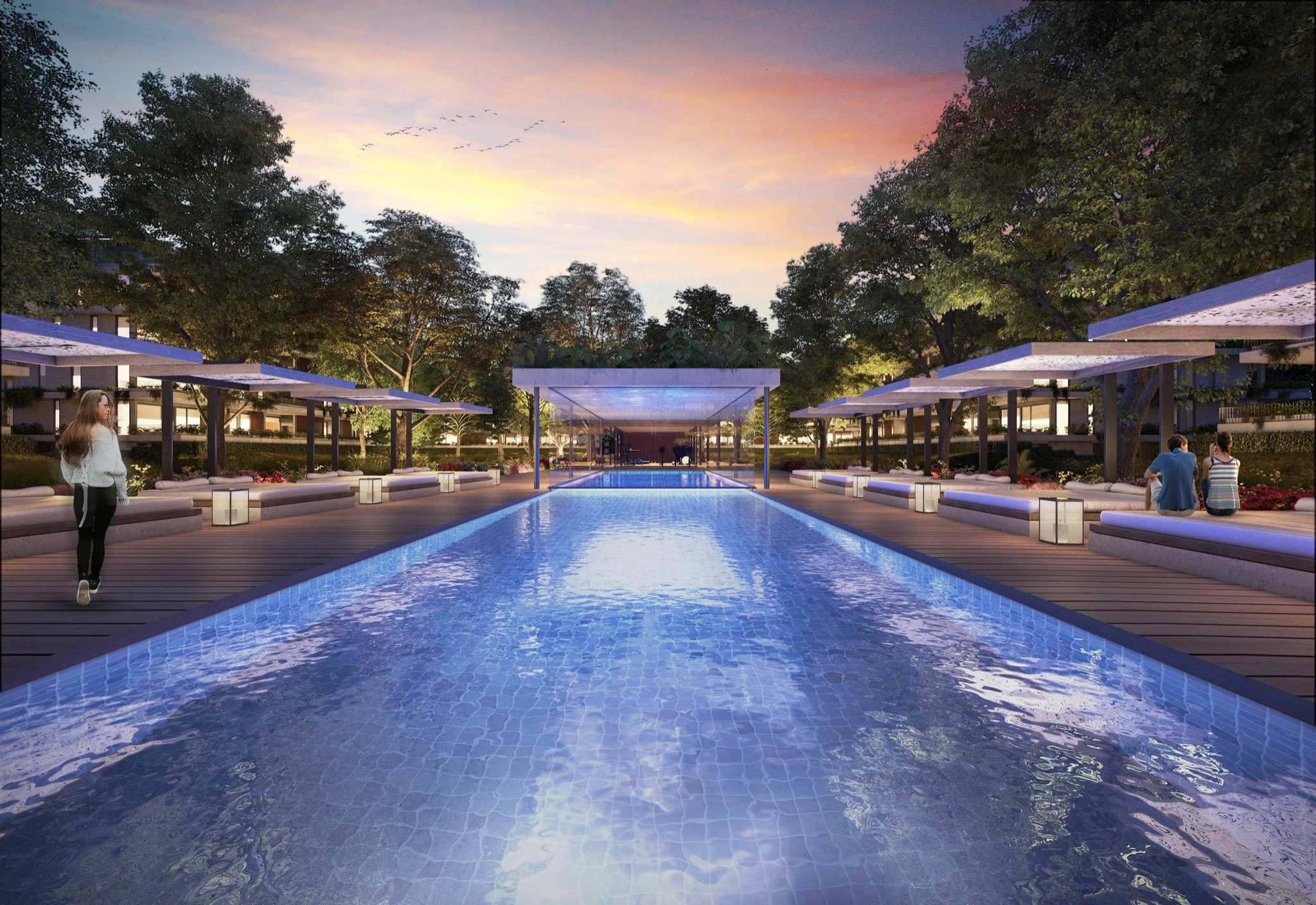 Piscina semi-olimpica al atardecer con pergolas y deck de madera